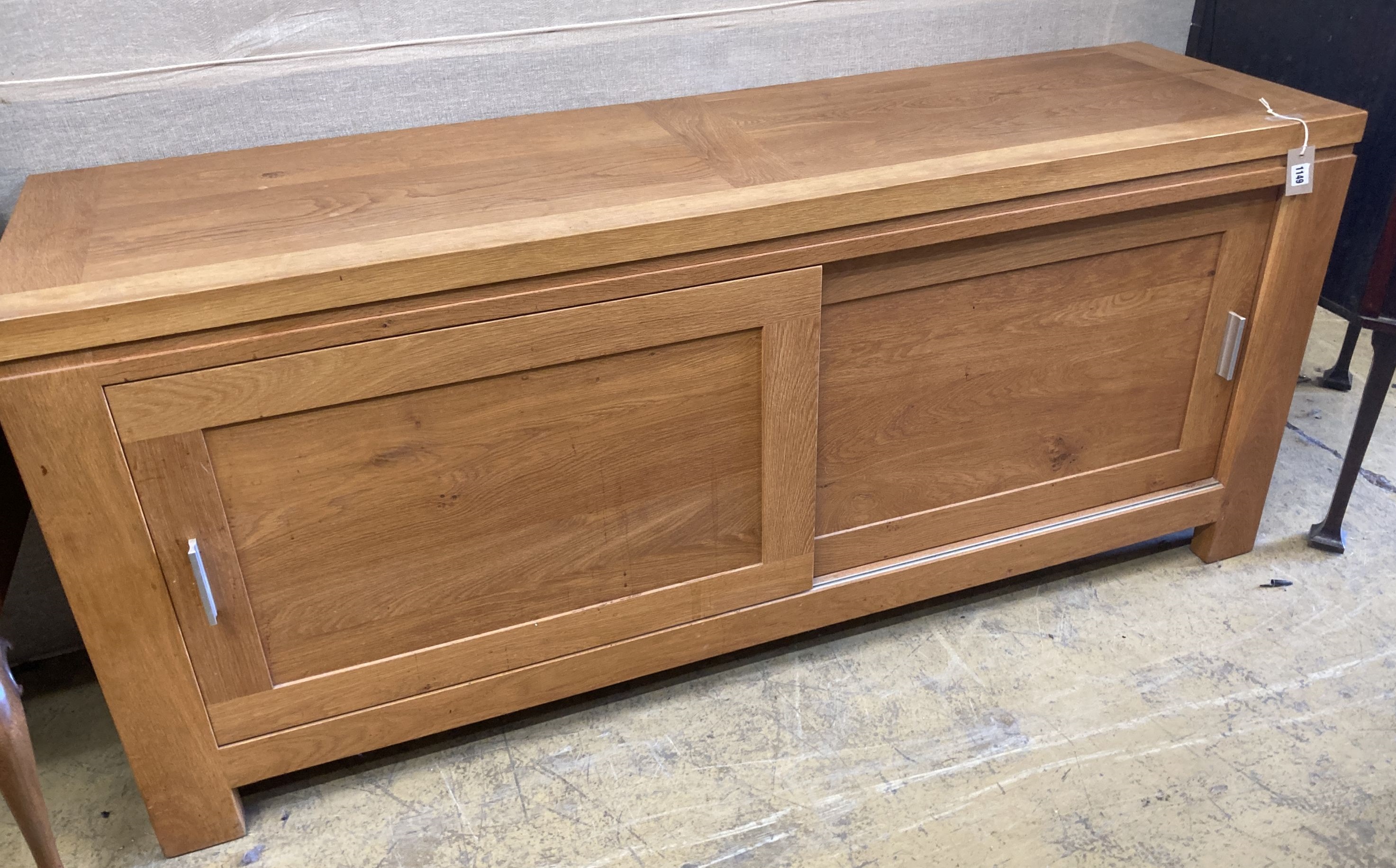 A contemporary light oak sliding door sideboard, length 178cm, depth 50cm, height 78cm